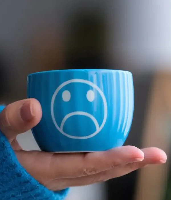 steps together blue face person holding cup with sad face it