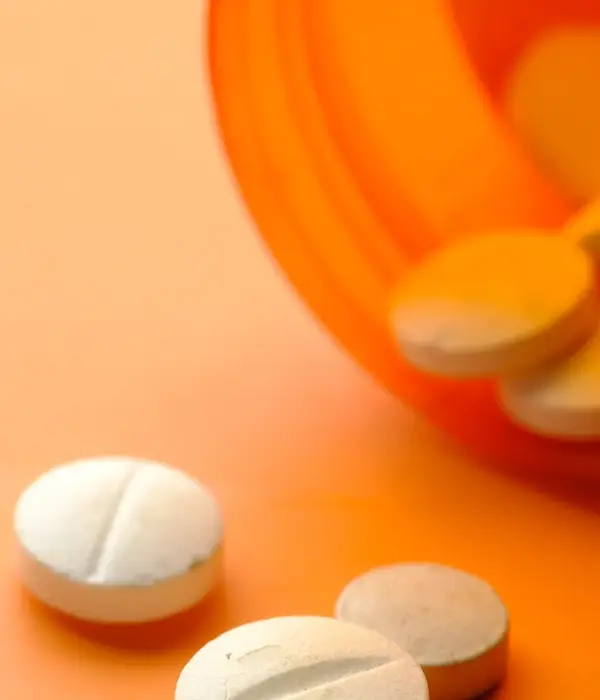 steps together opioid white color medical pills spilling orange background